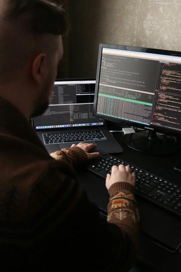 A man sitting in front of a computer on a desk