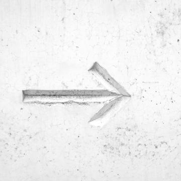 Arrow engraving on a white wall